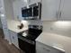 Modern kitchen with stainless steel appliances and white cabinets with under cabinet lighting at 131 Brown Swiss Cir, Summerville, SC 29483