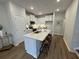 Bright kitchen with white cabinetry, stainless appliances, and a large island with barstool seating at 131 Brown Swiss Cir, Summerville, SC 29483