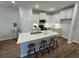 Bright kitchen with white cabinets, stainless steel appliances, a large island, and wood-style flooring at 131 Brown Swiss Cir, Summerville, SC 29483