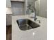 Close-up of kitchen island with stainless steel sink, faucet, and white countertop at 131 Brown Swiss Cir, Summerville, SC 29483