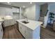 Bright kitchen featuring white cabinets, stainless steel appliances, and a large island with a stainless steel sink at 131 Brown Swiss Cir, Summerville, SC 29483
