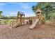 Community playground offers wooden play structures, a slide, and climbing features for outdoor fun at 131 Brown Swiss Cir, Summerville, SC 29483