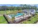 Aerial view of the community pool, featuring palm trees, lounge chairs, and clubhouse at 131 Brown Swiss Cir, Summerville, SC 29483
