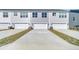 New townhome's rear exterior with driveways and garages in a well-maintained community at 131 Brown Swiss Cir, Summerville, SC 29483