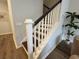 Modern staircase featuring dark wood steps, white risers and railings, and wood-style flooring at 131 Brown Swiss Cir, Summerville, SC 29483