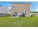 Exterior view of backyard featuring a small patio and green grass at 134 Stoney Creek Way, Moncks Corner, SC 29461