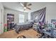 This bedroom features a large ceiling fan, a black bed, and cool skateboard decoration at 134 Stoney Creek Way, Moncks Corner, SC 29461