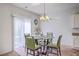 Bright dining area featuring modern chandelier, glass top table, and natural light from window at 134 Stoney Creek Way, Moncks Corner, SC 29461