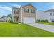 Charming two-story home featuring well-maintained lawn, attached garage, and classic curb appeal at 134 Stoney Creek Way, Moncks Corner, SC 29461