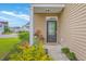 Inviting front porch with stylish decor, featuring a black door, and vibrant landscaping at 134 Stoney Creek Way, Moncks Corner, SC 29461