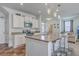 Modern kitchen with stainless steel appliances, counter seating, and open access to the living area at 134 Stoney Creek Way, Moncks Corner, SC 29461