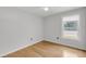 Bedroom with hardwood floors, and a window shows a view of the neighborhood at 1402 Camp Rd # 8B, Charleston, SC 29412
