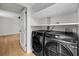 Modern laundry room featuring black Samsung washer and dryer with storage shelves at 1402 Camp Rd # 8B, Charleston, SC 29412