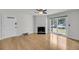 Open-concept living room with fireplace, hardwood floors, and natural light from sliding glass doors at 1402 Camp Rd # 8B, Charleston, SC 29412