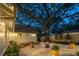 Backyard featuring a large shade tree, patio, and fire pit area at 1454 Seminole St, Mount Pleasant, SC 29464