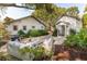 Inviting backyard patio area with white cushioned outdoor seating, manicured landscaping, and detached building at 1454 Seminole St, Mount Pleasant, SC 29464