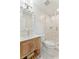Bright bathroom with decorative mirror, wood vanity, and glass-enclosed shower, combining style with functionality at 1454 Seminole St, Mount Pleasant, SC 29464