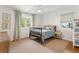 Light-filled bedroom with a wood-frame bed, neutral walls, ceiling fan and two windows at 1454 Seminole St, Mount Pleasant, SC 29464