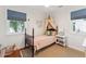 Bedroom featuring dark wood frame bed, blue window shades and a canopy tent at 1454 Seminole St, Mount Pleasant, SC 29464
