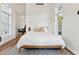 This sun-filled bedroom features hardwood floors, a large window, and comfortable furnishings, perfect for relaxation at 1454 Seminole St, Mount Pleasant, SC 29464