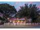 Charming home featuring mature trees, white picket fence, and inviting front porch at 1454 Seminole St, Mount Pleasant, SC 29464