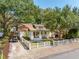 Charming home featuring mature trees, white picket fence, front porch and a golf cart at 1454 Seminole St, Mount Pleasant, SC 29464