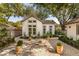 Exterior features a cozy cottage feel, highlighted by manicured shrubbery and beautiful trees at 1454 Seminole St, Mount Pleasant, SC 29464