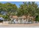 Charming home featuring mature trees, white picket fence, and inviting front porch at 1454 Seminole St, Mount Pleasant, SC 29464