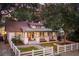Charming single story traditional-style home with white picket fence, beautiful lawn, and manicured landscaping at 1454 Seminole St, Mount Pleasant, SC 29464