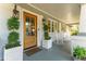 Inviting front porch with rocking chairs, stylish lighting, and a wooden front door at 1454 Seminole St, Mount Pleasant, SC 29464
