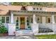 Charming front porch with decoratively potted shrubbery and rocking chairs, showcasing the entryway to the house at 1454 Seminole St, Mount Pleasant, SC 29464