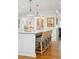 Kitchen island featuring marble countertops, wicker chairs and modern pendant lighting at 1454 Seminole St, Mount Pleasant, SC 29464