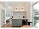 Stylish kitchenette with wet bar, floating shelves, a mini-fridge, and views into the adjacent bedroom at 1454 Seminole St, Mount Pleasant, SC 29464