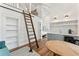 Charming open-concept space with a loft ladder, kitchenette, and bedroom, creating a cozy and functional design at 1454 Seminole St, Mount Pleasant, SC 29464