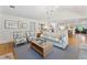 Bright living room featuring stylish seating, a woven coffee table, and an open layout with access to the kitchen at 1454 Seminole St, Mount Pleasant, SC 29464