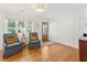 Bright living room featuring hardwood floors, wainscoting, and natural light from the large windows at 1454 Seminole St, Mount Pleasant, SC 29464