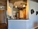 Modern kitchen featuring a stainless-steel fridge, bar seating and concrete ceiling at 150 Bee St # 611, Charleston, SC 29401