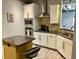 Well-equipped kitchen with white cabinets, stainless steel appliances, and breakfast bar with a granite countertop at 150 Bee St # 611, Charleston, SC 29401