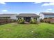 Spacious backyard with a lawn, manicured bushes, and a patio, perfect for outdoor activities at 1513 Thin Pine Dr, Johns Island, SC 29455