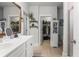Bright bathroom with walk-in closet access, dual vanity sinks, and a neutral color palette at 1513 Thin Pine Dr, Johns Island, SC 29455