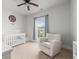 Comfortable Bedroom featuring a crib, chair, and neutral color scheme, perfect for a new baby at 1513 Thin Pine Dr, Johns Island, SC 29455