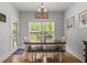 Cozy dining area features a rustic wood table, bench seating, and natural light from the window at 1513 Thin Pine Dr, Johns Island, SC 29455