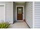 A welcoming front porch features a rustic wood door and a cozy 'Welcome Home' doormat at 1513 Thin Pine Dr, Johns Island, SC 29455