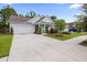 Charming single-story home features a well-manicured lawn, a two-car garage, and inviting front porch at 1513 Thin Pine Dr, Johns Island, SC 29455