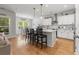 Open-concept kitchen with white cabinetry, a large island, and wood floors flows into a breakfast area at 1513 Thin Pine Dr, Johns Island, SC 29455