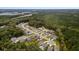 Picturesque aerial view of suburban homes nestled amongst lush green trees with a pond in the distance at 154 Boots Branch Rd, Summerville, SC 29485