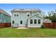 Stunning back view of a house featuring solar panels, a fenced yard, and outdoor patio at 154 Boots Branch Rd, Summerville, SC 29485