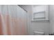 Clean bathroom features shower with a white and pink shower curtain, window, and toilet at 154 Boots Branch Rd, Summerville, SC 29485