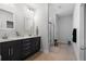 Bathroom with double vanity, dark cabinets, and a glass-enclosed shower at 154 Boots Branch Rd, Summerville, SC 29485