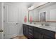 Bathroom with double sink vanity, modern fixtures, and a large mirror with decorative gold trim at 154 Boots Branch Rd, Summerville, SC 29485